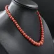 Vintage halskæde med store polerede koral-perler i forløb - fra siden