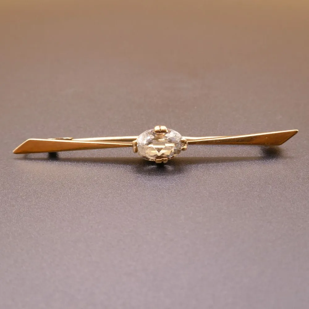 Vintage 14 karat guldbroche prydet med stor klar sten