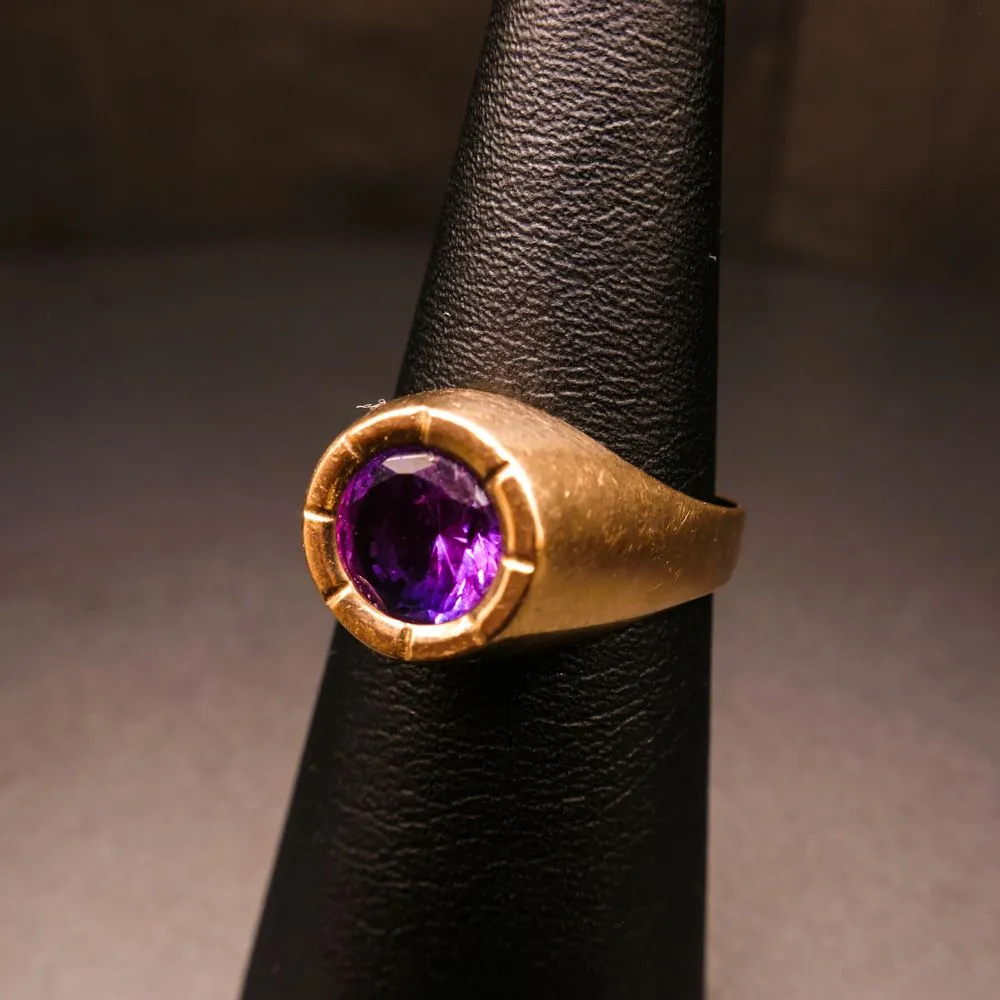 Guldring af otte karat prydet med varm mørklilla sten